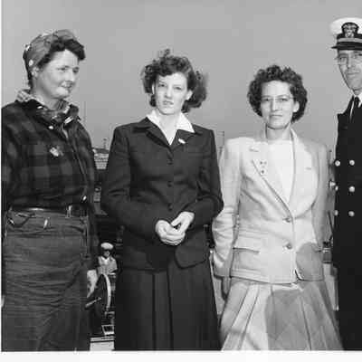 Three female L.D. Smith employees wearing award pins