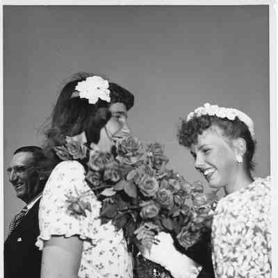 Miss Joan Burgess holding roses at PC-1175 christening