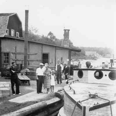 Harris family satnding on dock with Hope in water