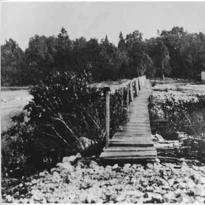 wooden footbridge at Cana Island with boathouse in background