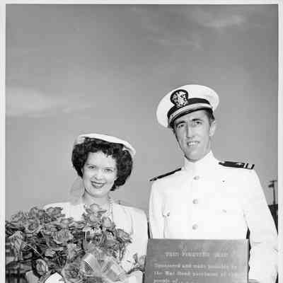 PC-1173 Ship sponsor holding flowers next to officer at ship christening