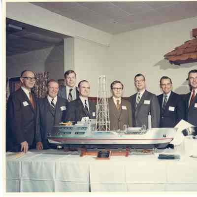 Group of men posing behind Aloca Seaprobe model