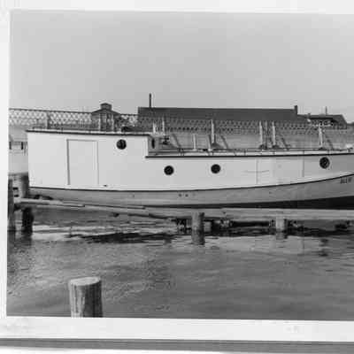 Fishing tug Allie docked next to bridge
