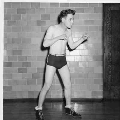 Man with shirt off in boxing stance