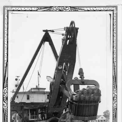 Dredge at work with one man on deck