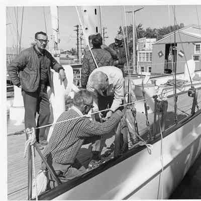 Men on deck of Firebird at Palmer Johnson