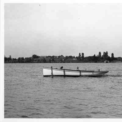 white vessel with two mean above gunwale