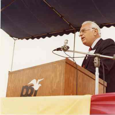 PBI man at podium at christening of Captain Frank Medina