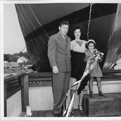 Two adults and one child with bottle of champagne at SBSB&DD Co.