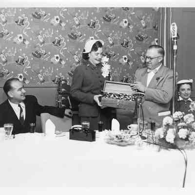 C. Ray Christianson giving Joan McCarthy LST-1170 sponsor case May 22, 1954