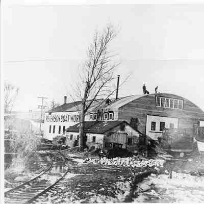 People roofing Peterson Boat Works building