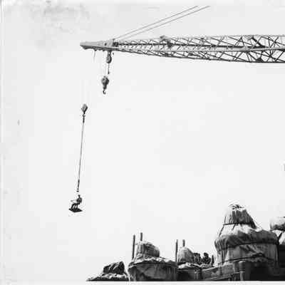 Crane at L.D. Smith Co. holding man in cage in the air