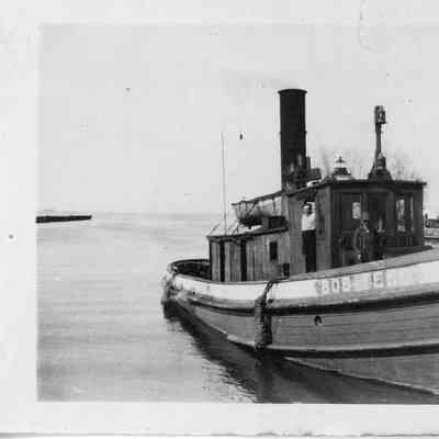 Wooden tug Bob Teed with two men on board