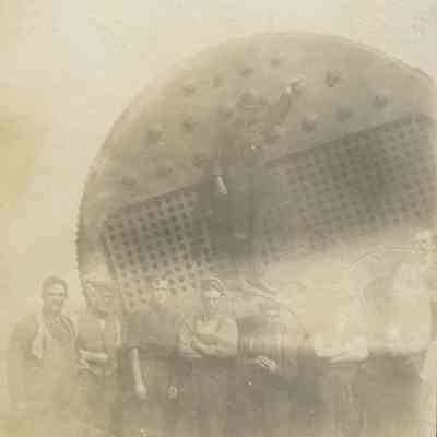 Workers in front of ship's boiler
