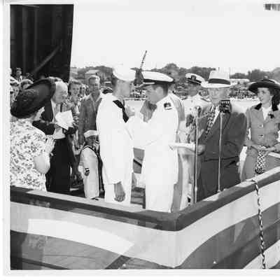 L.D. Smith at microphone in sponsor box at christening of AK-207 USS Richland