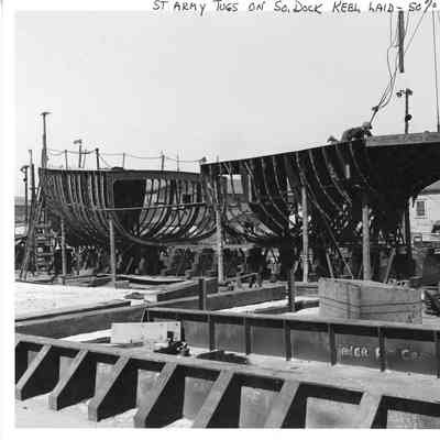 ST Army tugs on southern dock with keel laid April 10, 1945