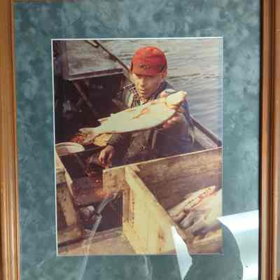 Framed Photograph of a Fisherman Sorting His Catch