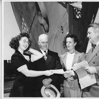 Four people at the christening of PC-1566