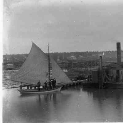sail boat by saw mill