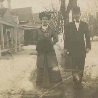 Well dressed couple on sidewalk