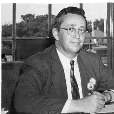 Man in suit and worker's ID at desk