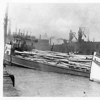 Tug George Nelson with Pewaukee heaviy laden with logs