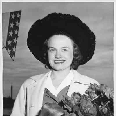 Mrs. George Reeke holding roses