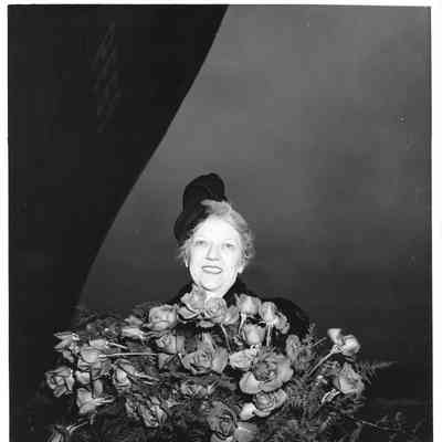 Mrs. Edward Frick holding roses
