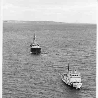 USCGC 103 Mobile Bay towing freighter