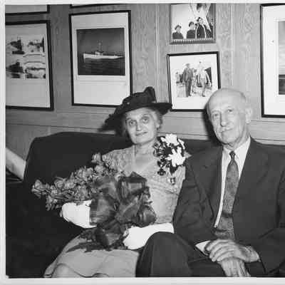 Mrs. Cecila Daniel and Mr. Daniel sitting on couch