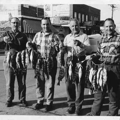 Four men holding string of fish 1966