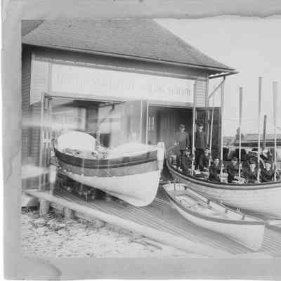 USLSS boat house with men with paddles in a boat