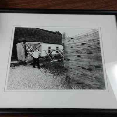 Framed photograph of Leon Voight carrying big mesh at Gills Rock