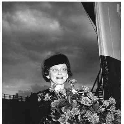 Mrs. John Butterweck holding roses