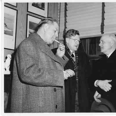 Three unidentified men standing and conversing in Leathem D. Smith Shipbuilding office