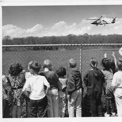Children watching coast guard helicopter