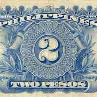 The image depicts the back of a vintage two-peso currency bill from the Philippines. The bill is a light, cream color with blue designs. At the center, a large numeral "2" is prominently displayed within an elaborate circular frame that is set against a leafy vine and plaque. The words "TWO PESOS" appear in banners above and below the central design, with additional "2" numerals in varying decorative frames at each corner.