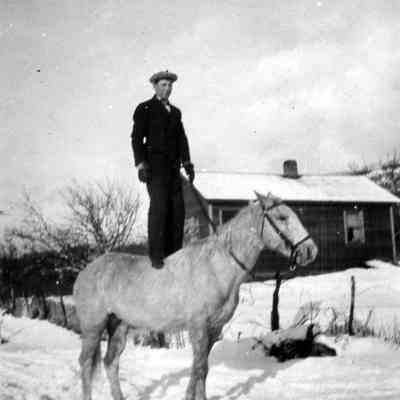 Man Standing on Horse