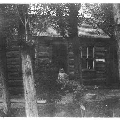 Girl in Front of Cabin