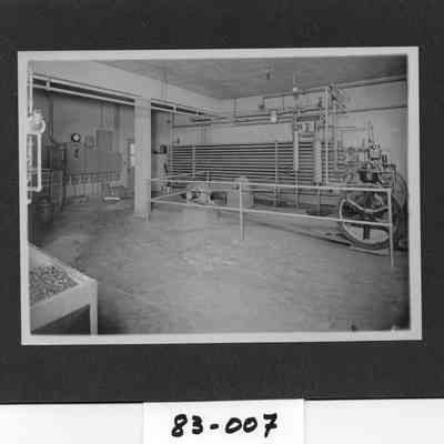 Twin City Creamery butter making equipment, with Margaret Schaffner Schuster, butter cutter Guy Lyons, butter and ice cream maker, and Joe Allen, milk processor and ice cream maker.