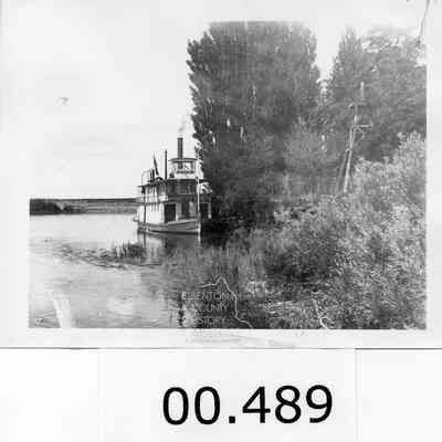 Gerome, Steamboat, tied up to the shore.