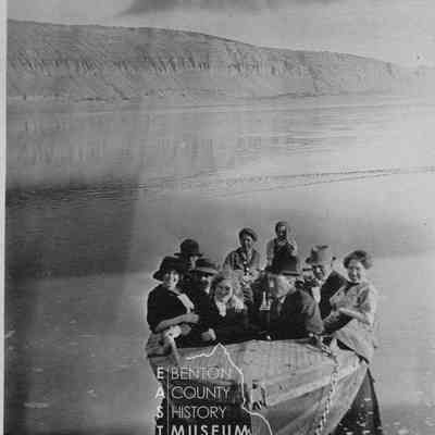 River party in small dinghy with White Bluffs in the background