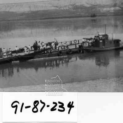 Doris Ferry, with the White Bluffs Band , in white clothing on the Hanford Ferry Slip, During the dedication ceremonies. The tug Doris, and the Ferry Barge.