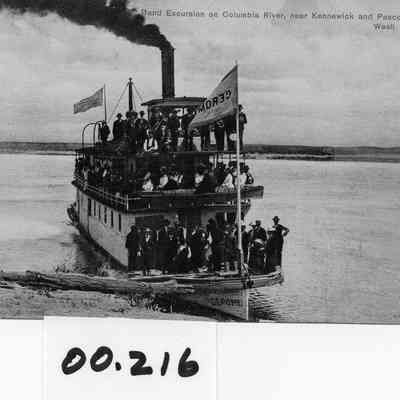 Gerome, loaded with passengers at river shore. Caption reads "Band Excursion on the Columbia River near Kennewick and Pasco."