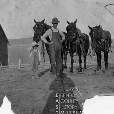 William Amon and his son Elmer with four saddled horses on the Amon Ranch, 1915.