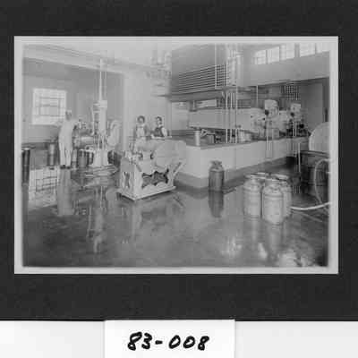 Twin City Creamery butter making equipment, with Margaret Schaffner Schuster, butter cutter Guy Lyons, butter and ice cream maker, and Joe Allen, milk processor and ice cream maker.