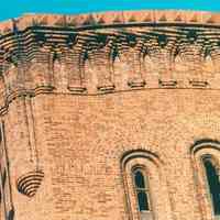 Digital image of color photo of an exterior detail at the top of a tower at the former Hudson & Manhattan Rail Road powerhouse, Jersey City, Nov., 199