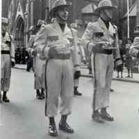 B+W photo of James Radigan marching in Holy Name Day Parade with Lenape Lancers, O.L.G. Senior Drum Corps, Hoboken, Oct. 1951.