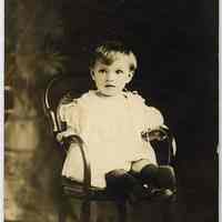 Sepia-tone photos, 2, of a young boy seated in chair; three children; posed in studio with interior backdrop, Hoboken, n.d., ca. 1910-1930.