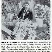 Reference image: Mayor George Steil surrounded by floral tributes from well wishers in Hoboken City Hall office, Hoboken, Jan. 1, 1906.